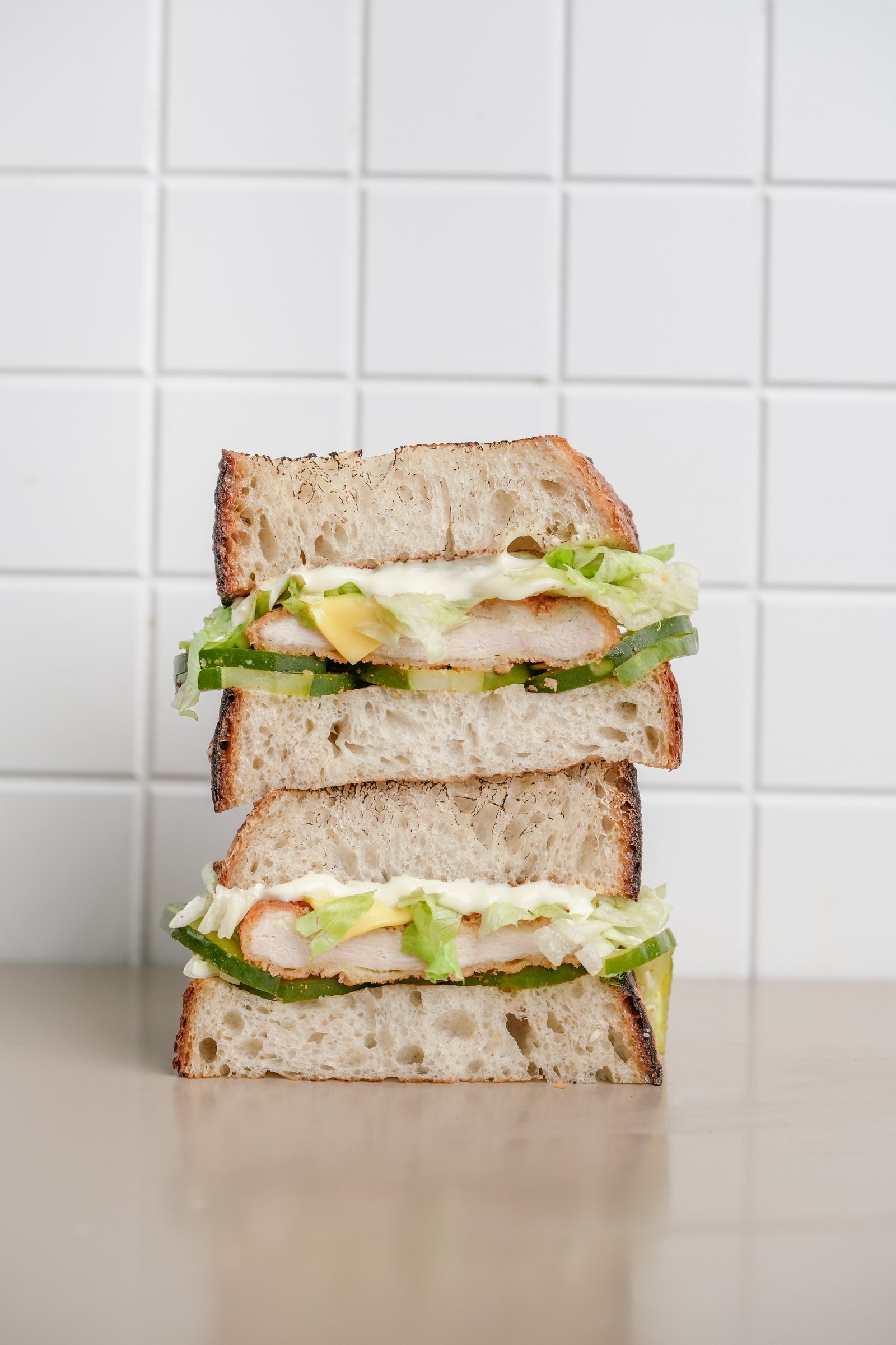 Chic Chick — sourdough, chicken breast, yellow cheese, mayonnaise, shredded lettuce, cucumber pickles